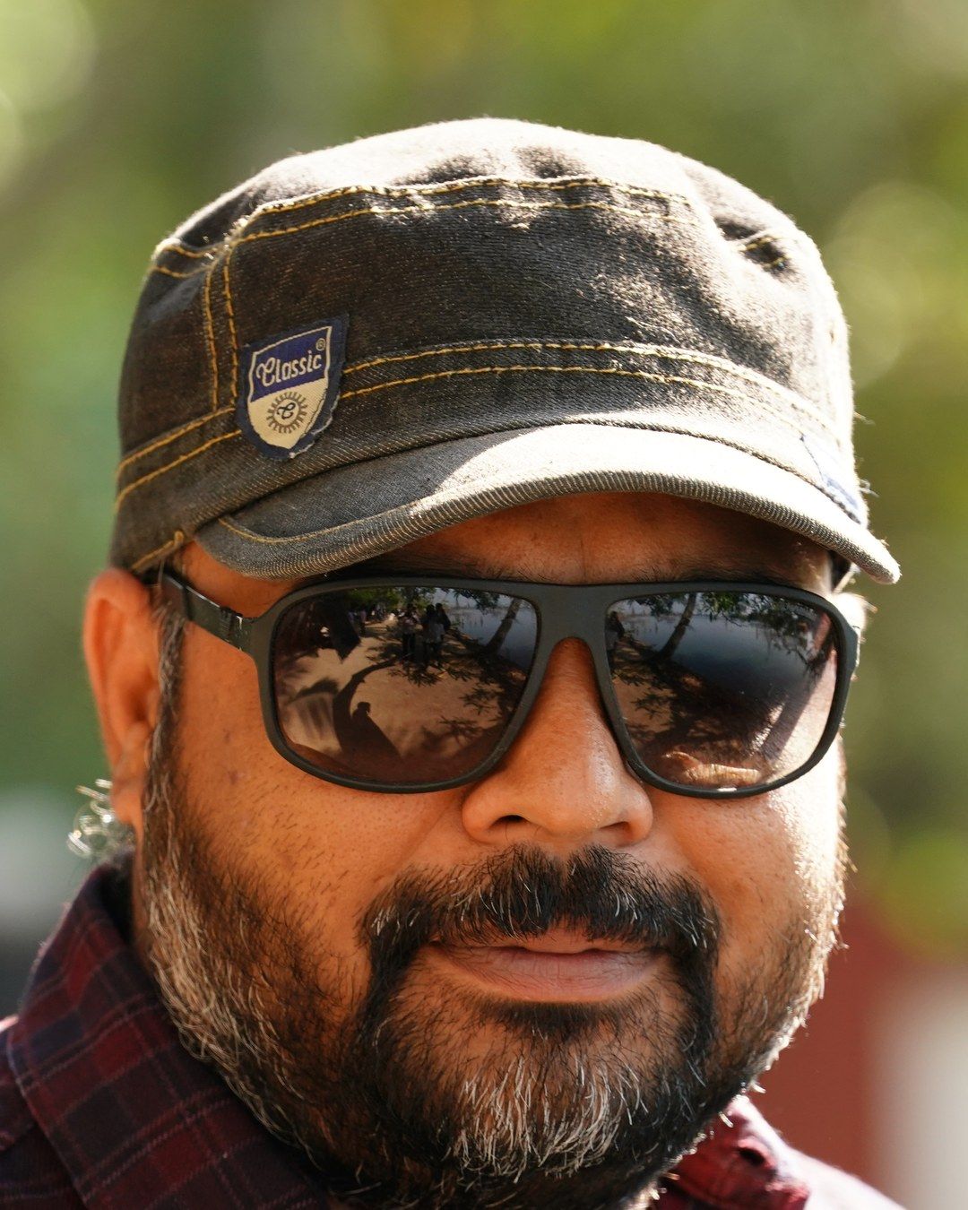 Vysakh in sunglasses and a cap, close-up portrait