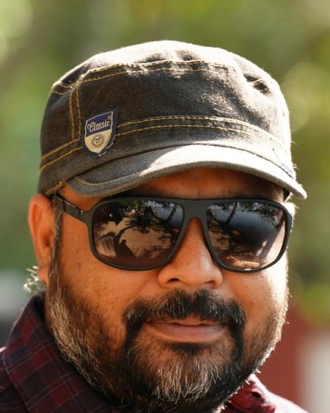 Vysakh in sunglasses and a cap, close-up portrait