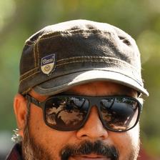 Vysakh in sunglasses and a cap, close-up portrait