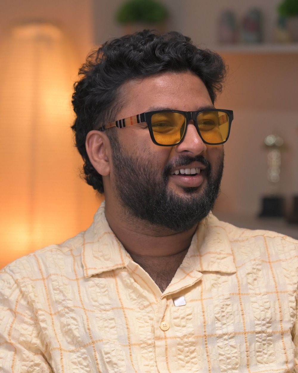 Shahad Nilambur in tinted glasses and a beige shirt, portrait
