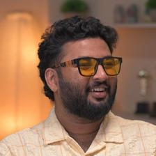 Shahad Nilambur in tinted glasses and a beige shirt, portrait