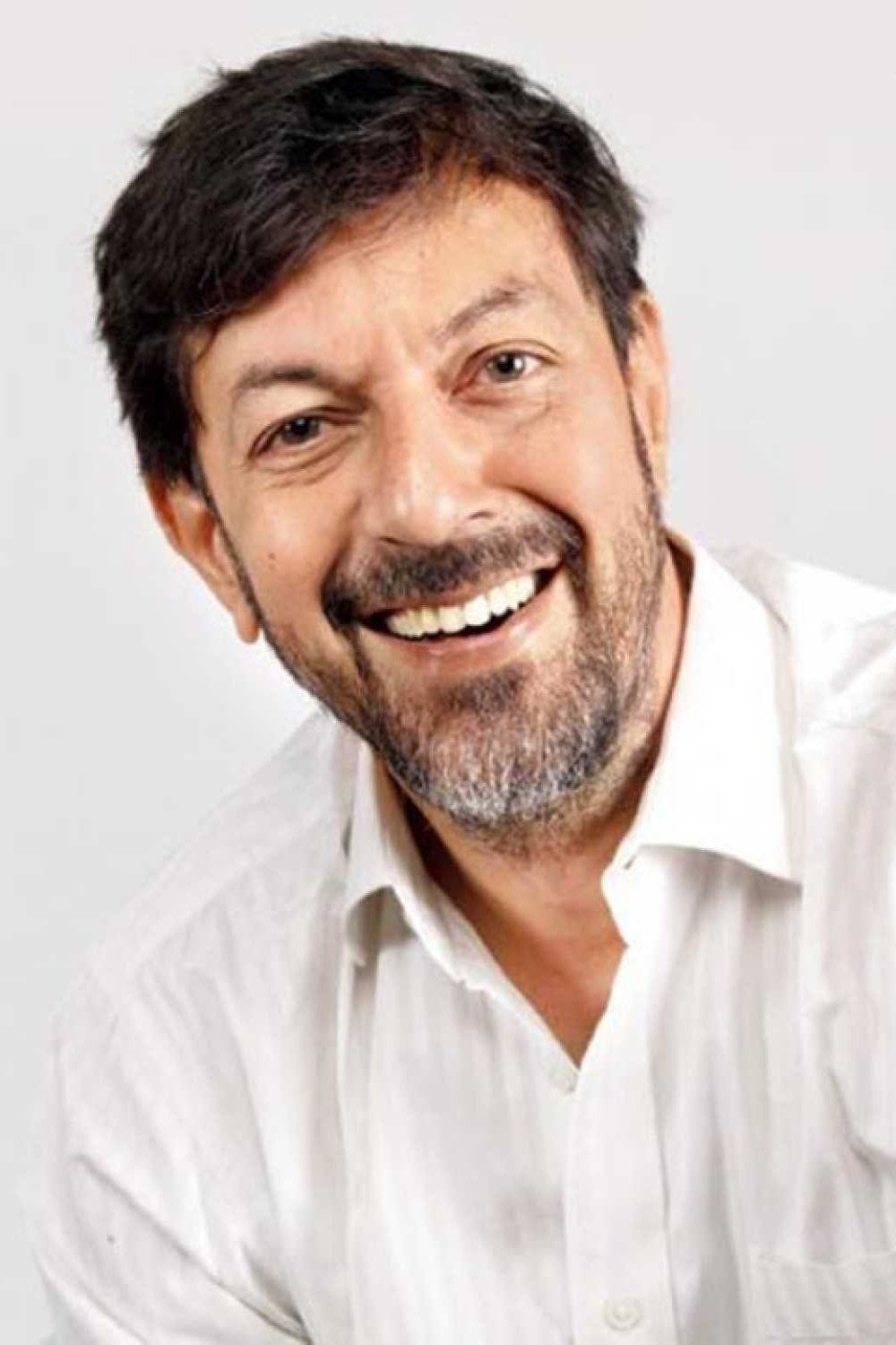 Rajat Kapoor smiling in a white shirt, close-up portrait