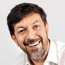 Rajat Kapoor smiling in a white shirt, close-up portrait