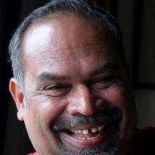 Alencier Ley Lopez in a red shirt, laughing, close portrait