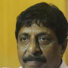 Sreenivasan with a moustache looking at the camera, close-up portrait