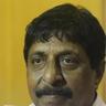 Sreenivasan with a moustache looking at the camera, close-up portrait