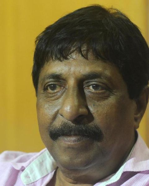 Sreenivasan with a moustache looking at the camera, close-up portrait