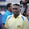 I. M. Vijayan in a yellow polo shirt among people outdoors