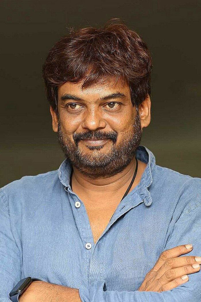 Puri Jagannadh with arms crossed in a blue linen shirt, smiling