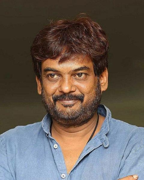Puri Jagannadh with arms crossed in a blue linen shirt, smiling