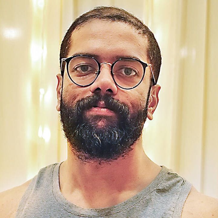 Govind Vasantha in glasses with a full beard, close-up portrait
