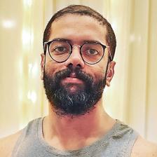 Govind Vasantha in glasses with a full beard, close-up portrait