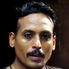 Sujith Shanker with a moustache in a dark T-shirt, portrait