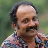 Jibin Gopinath with a moustache in a patterned shirt, smiling
