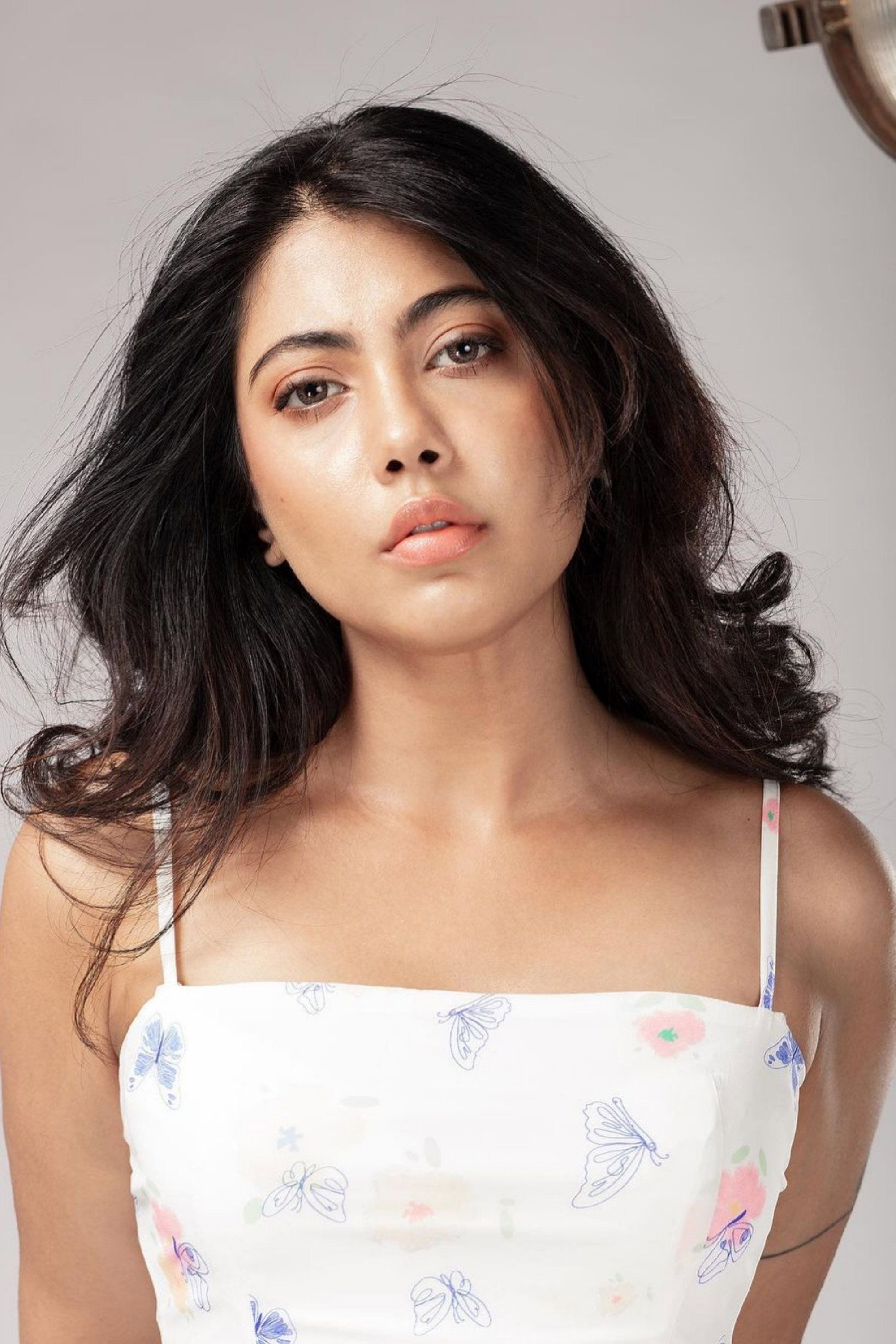 Nayana Elza in a white top with long dark hair, portrait