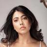 Nayana Elza in a white top with long dark hair, portrait