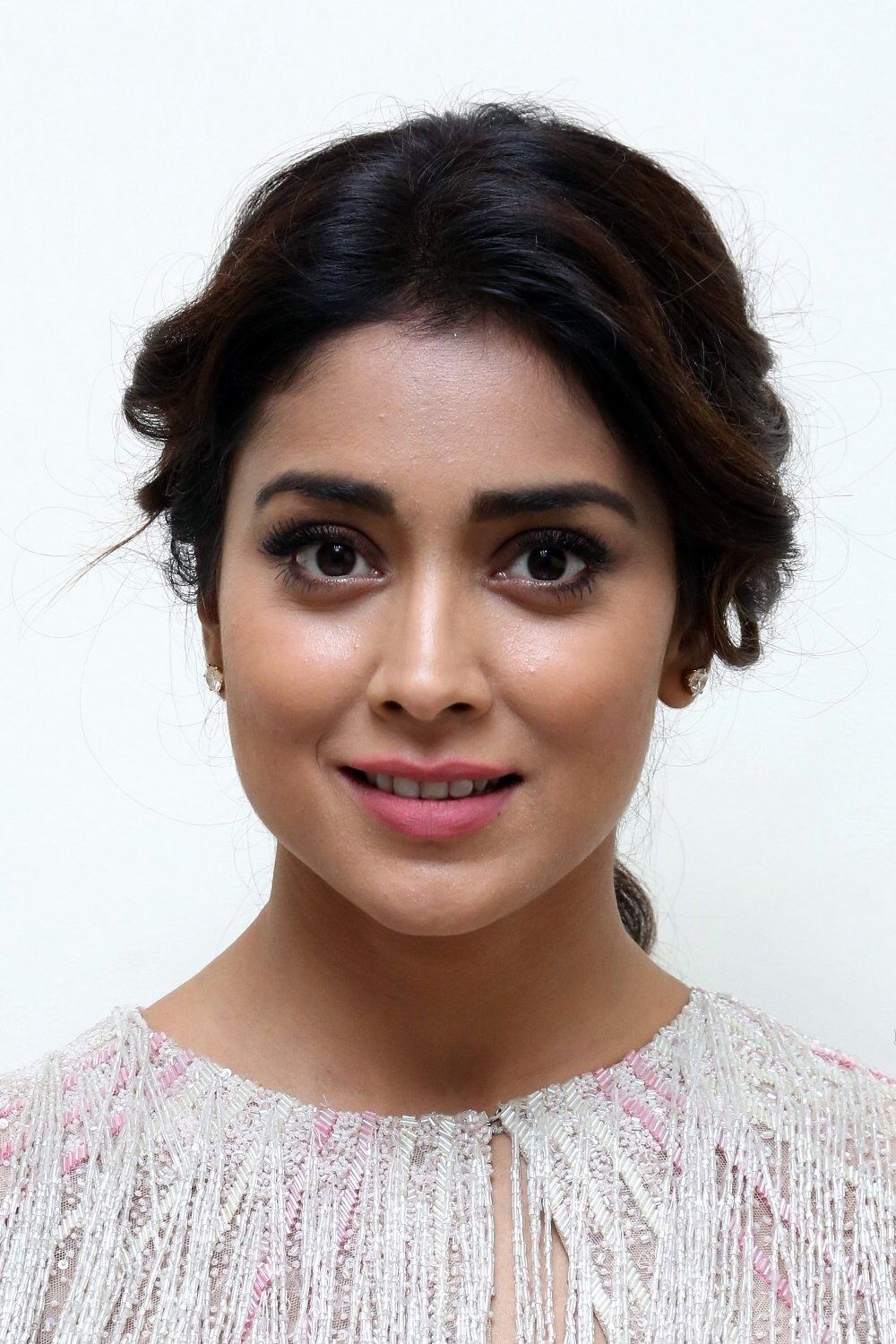 Shriya Saran smiling with her hair tied back, close-up portrait