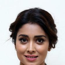 Shriya Saran smiling with her hair tied back, close-up portrait
