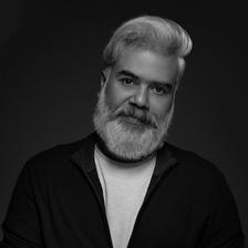 Ranjan Pramod with a grey beard in a dark shirt, black and white