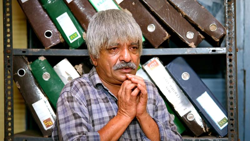 Jaffer Idukki, grey-haired, with his hands clasped in a still from the Sidhu trailer