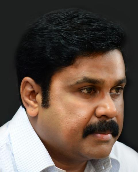 Dileep with a moustache in a white shirt, close-up portrait