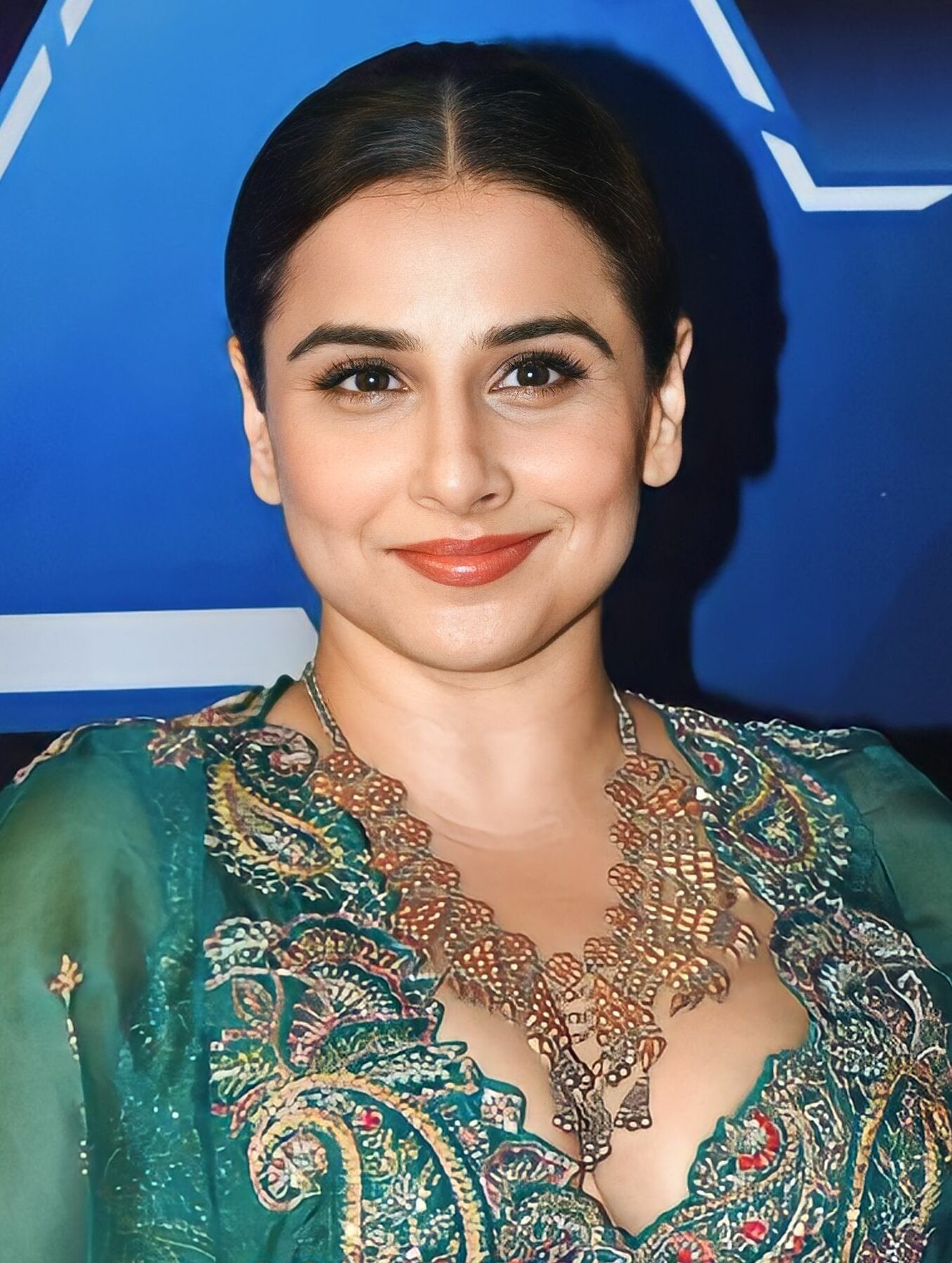 Vidya Balan smiling in a green embroidered outfit, portrait