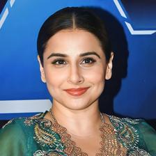 Vidya Balan smiling in a green embroidered outfit, portrait