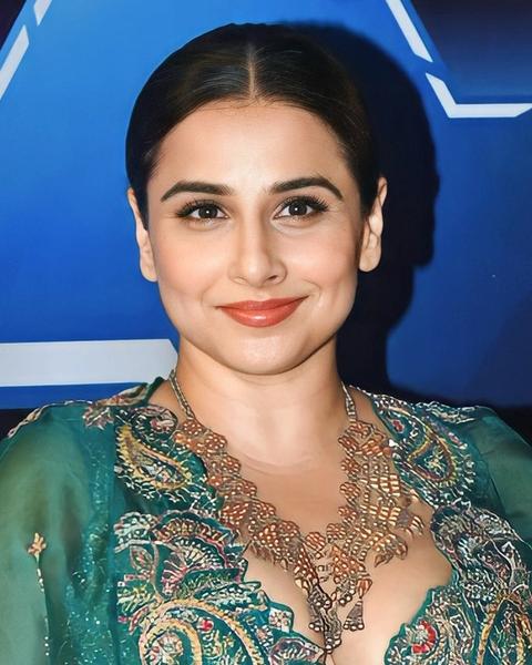 Vidya Balan smiling in a green embroidered outfit, portrait