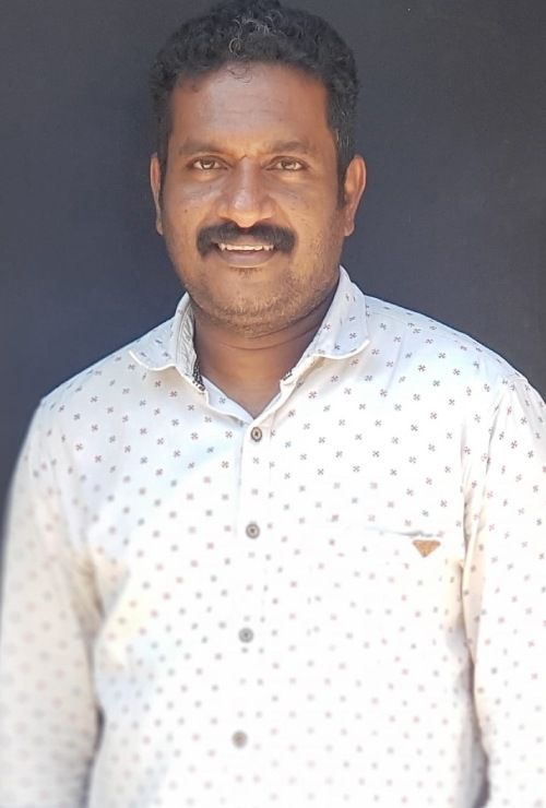 Kiran Peethambaran in a white printed shirt outdoors, portrait