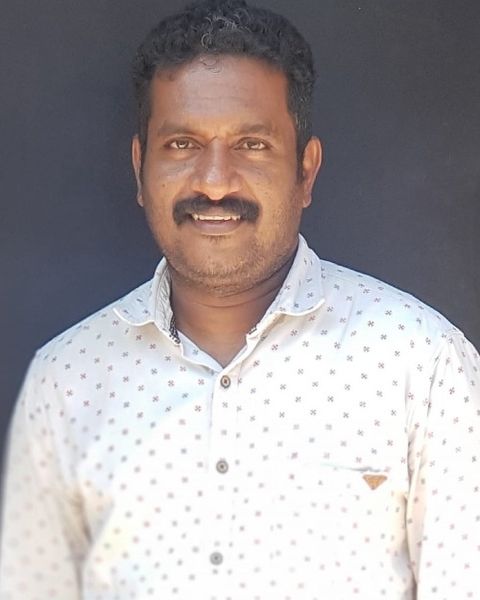 Kiran Peethambaran in a white printed shirt outdoors, portrait
