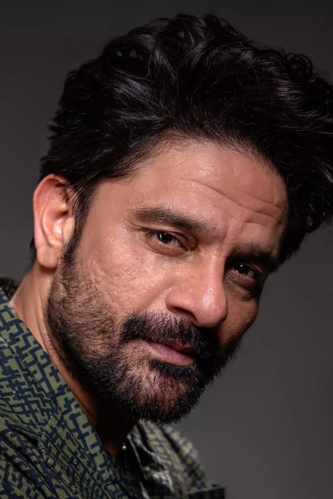 Jaideep Ahlawat with a beard looking at the camera, close-up portrait