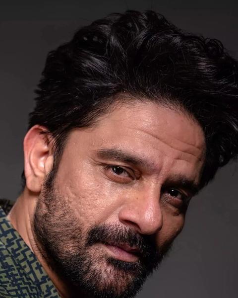 Jaideep Ahlawat with a beard looking at the camera, close-up portrait