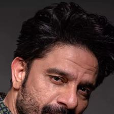 Jaideep Ahlawat with a beard looking at the camera, close-up portrait