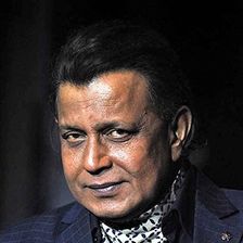 Mithun Chakraborty in a dark suit and patterned scarf, portrait