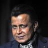 Mithun Chakraborty in a dark suit and patterned scarf, portrait