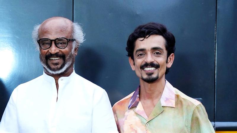 Rajinikanth and Rajesh Madhavan smiling together outside a caravan on the Jailer 2 set