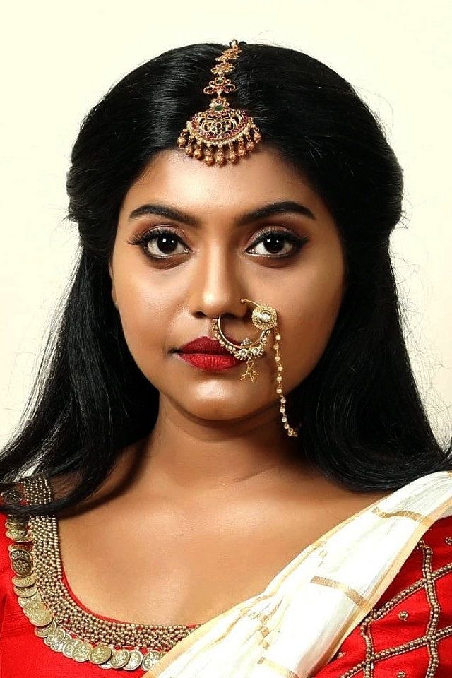 Sruthy Jayan in bridal jewellery with a nose ring, portrait