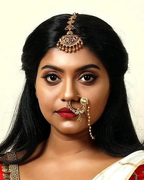 Sruthy Jayan in bridal jewellery with a nose ring, portrait
