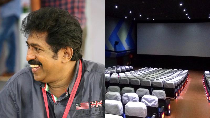 KSFDC chairman Prem Kumar smiling at IFFK, beside the KSFDC Sree theatre auditorium