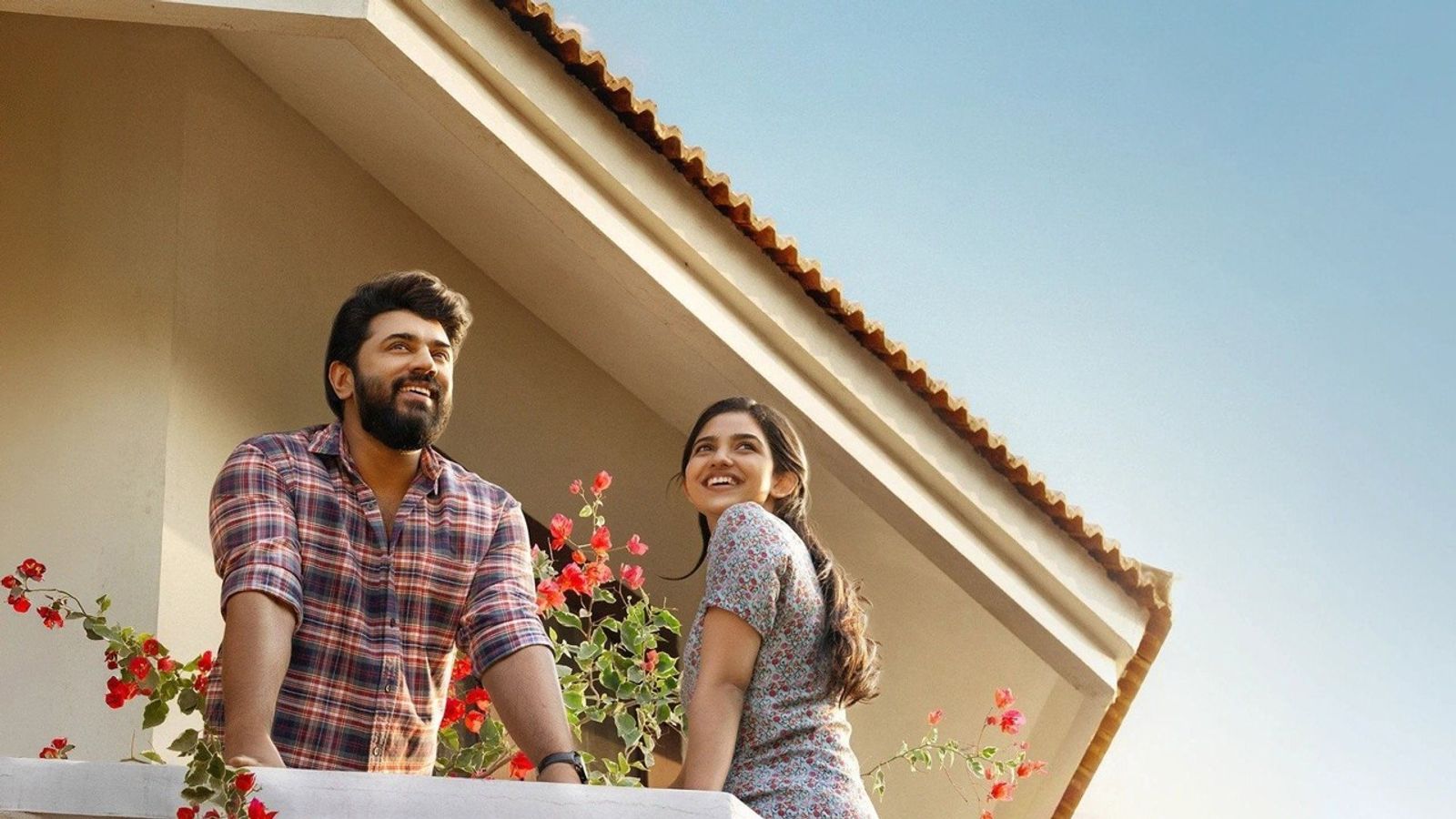 Nivin Pauly and Mamitha Baiju on a balcony in the official Bethlehem Kudumba Unit poster