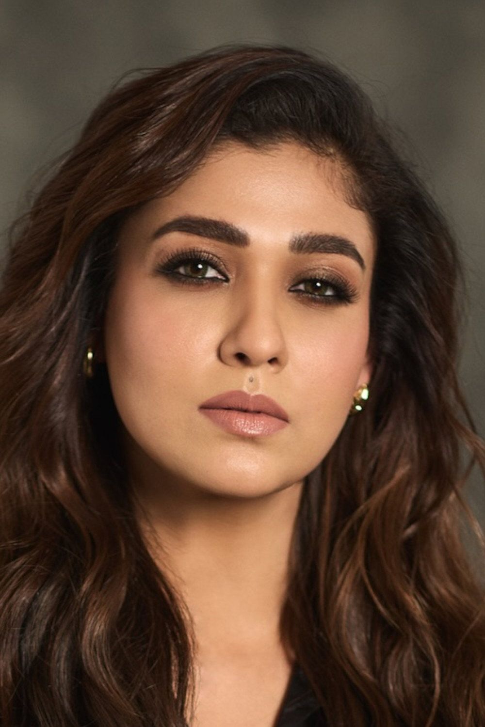 Nayanthara with long wavy hair, close-up portrait