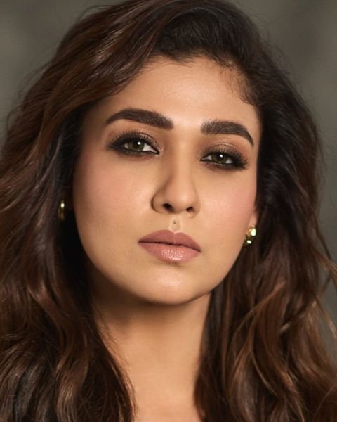Nayanthara with long wavy hair, close-up portrait