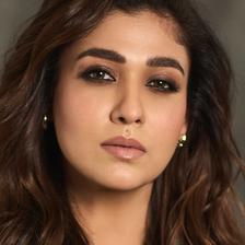 Nayanthara with long wavy hair, close-up portrait