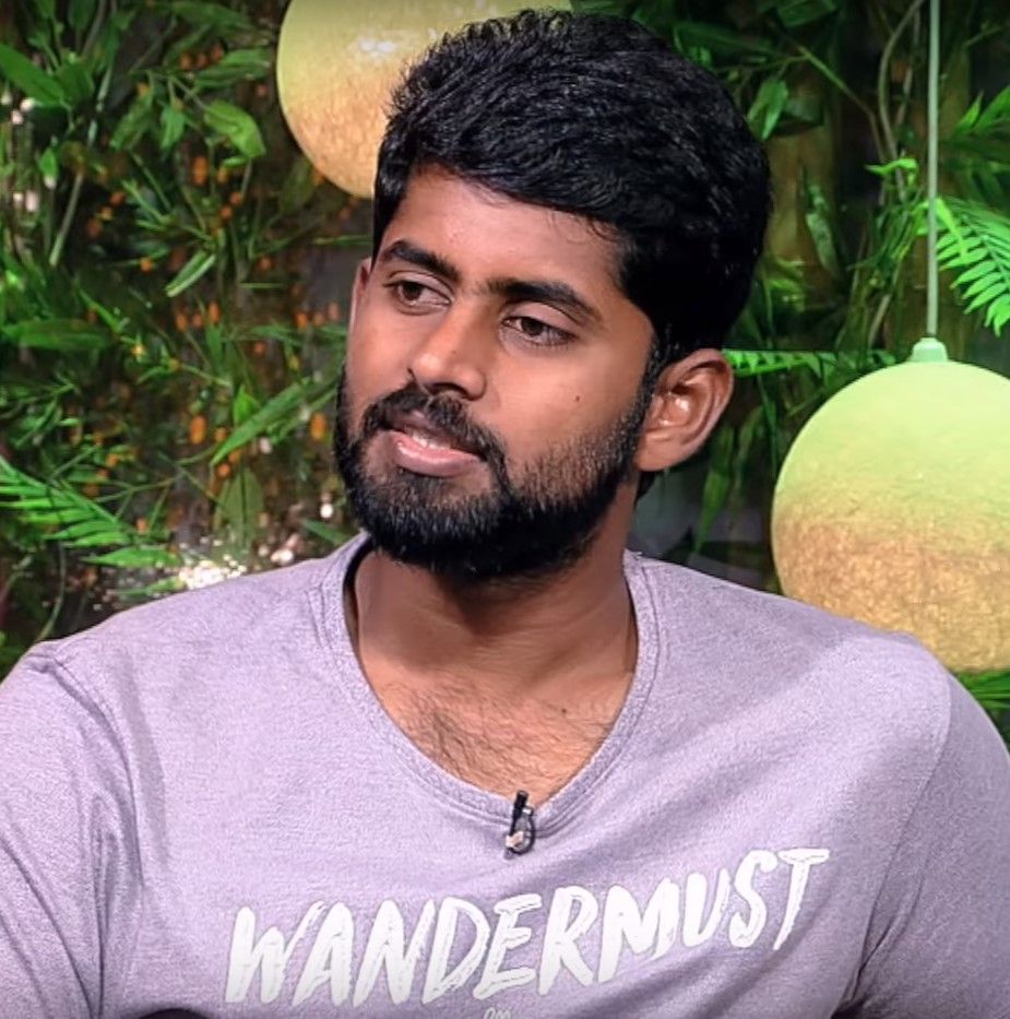 Kathir in a lavender T-shirt, head-and-shoulders portrait