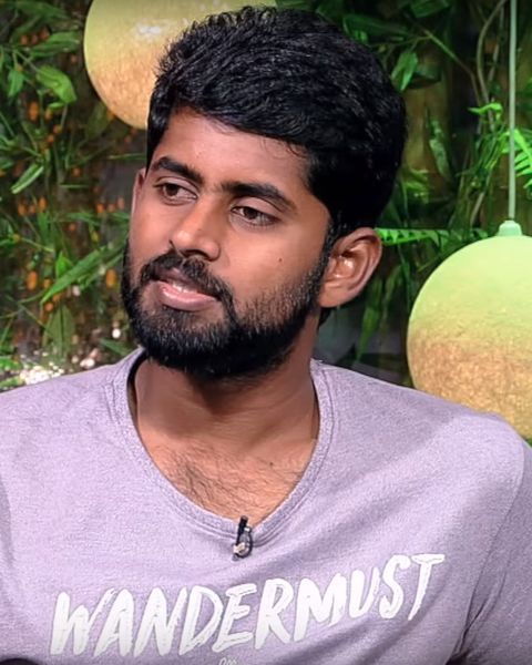 Kathir in a lavender T-shirt, head-and-shoulders portrait