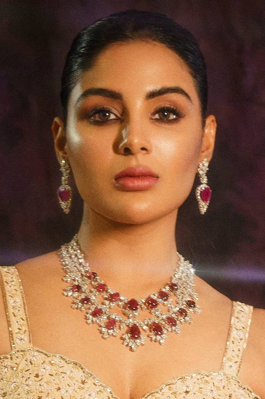 Samyuktha in a ruby and diamond necklace with matching earrings, hair pulled back