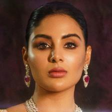 Samyuktha in a ruby and diamond necklace with matching earrings, hair pulled back