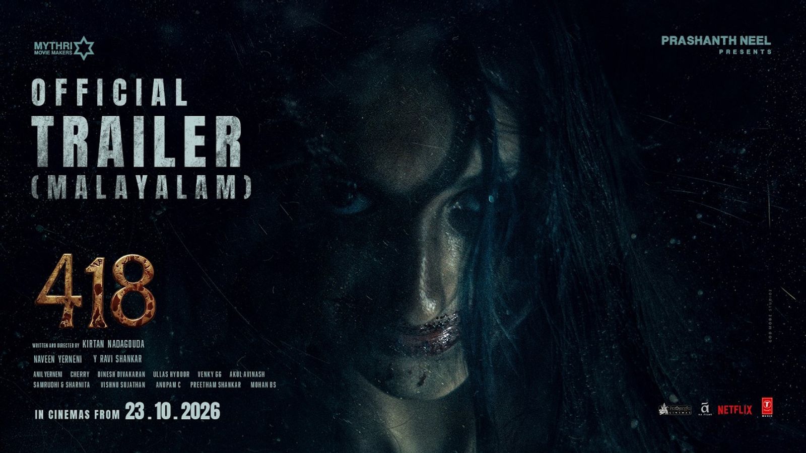 A pale, long-haired woman stares out of the dark in the 418 Malayalam trailer card.