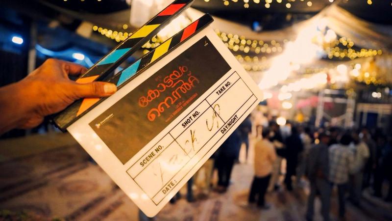 A pack-up clapboard for Kottayam Belt held up on the film's set at night