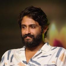Antony Varghese in a white patterned shirt, half-length portrait